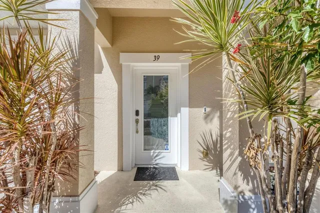 a bedroom with a large window and a potted plant