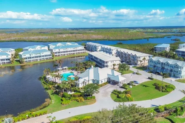a dining room with furniture and floor to ceiling window