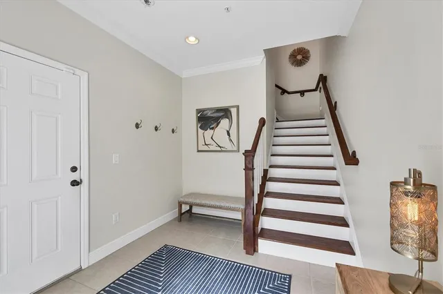 a view of a hallway with dining room and front door
