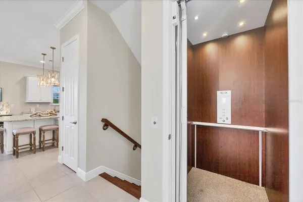 a living room with furniture chandelier and fireplace