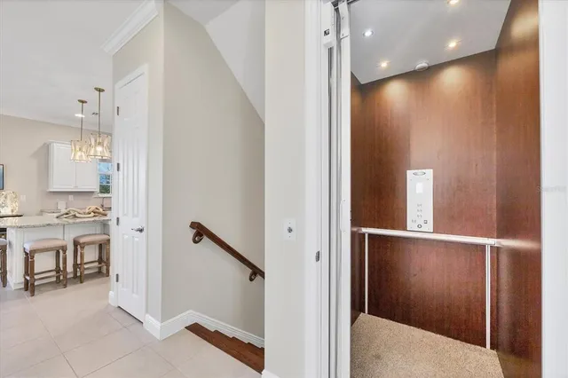a living room with furniture chandelier and fireplace
