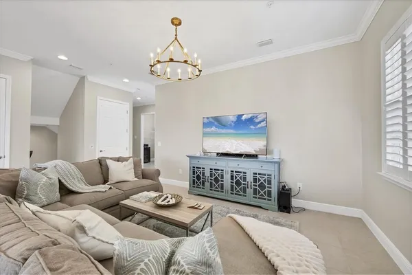 a kitchen with stainless steel appliances kitchen island granite countertop a table chairs refrigerator and microwave