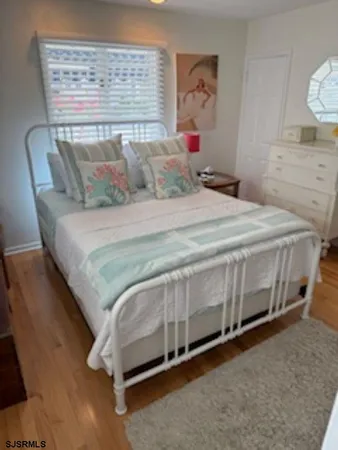 a bedroom with a bed and painting on the wall