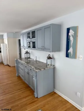 a kitchen with stainless steel appliances granite countertop a sink stove and wooden floor
