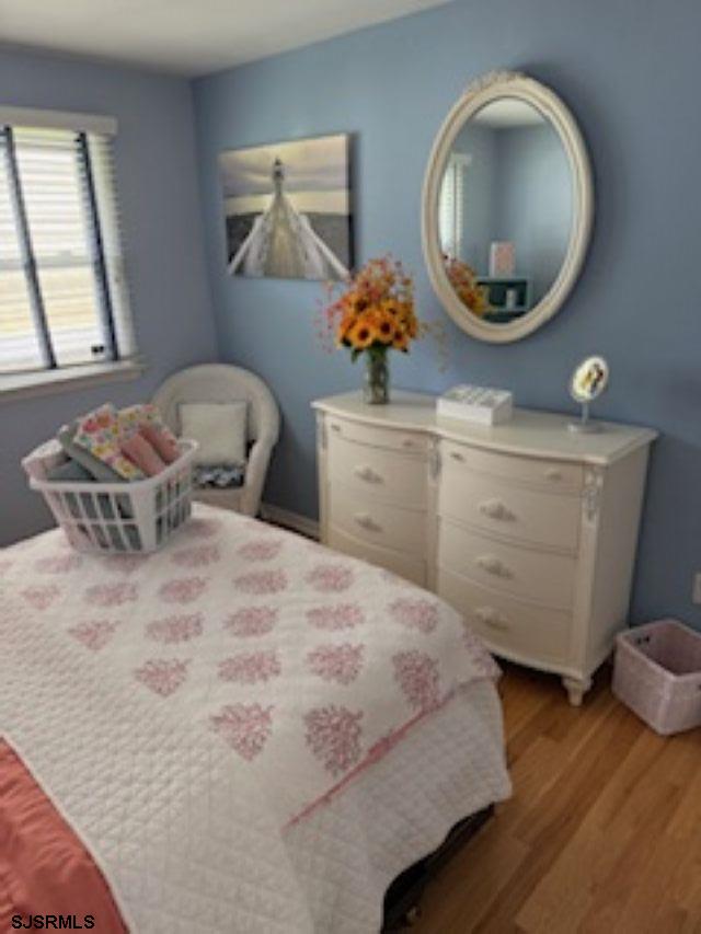 131 North Yarmouth Avenue, Unit JUNE 2026 Longport, NJ 08403 - Photo 9 of 18 a bedroom with a bed and window