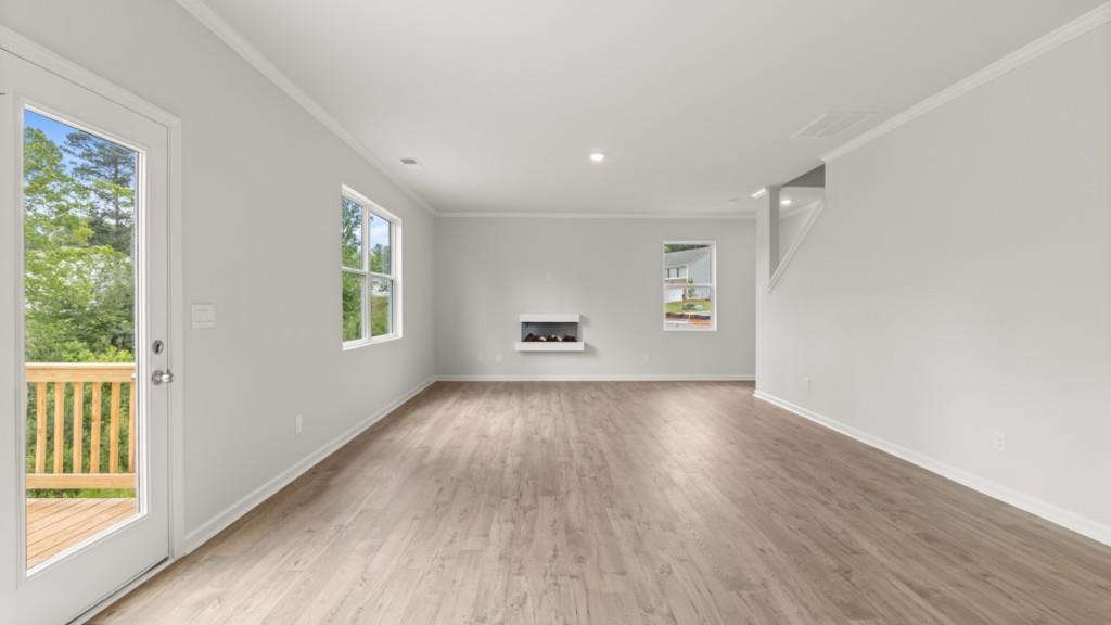174 Thompson Ridge Lane Dallas, GA 30132 - Photo 14 of 35 an empty room with wooden floor and windows