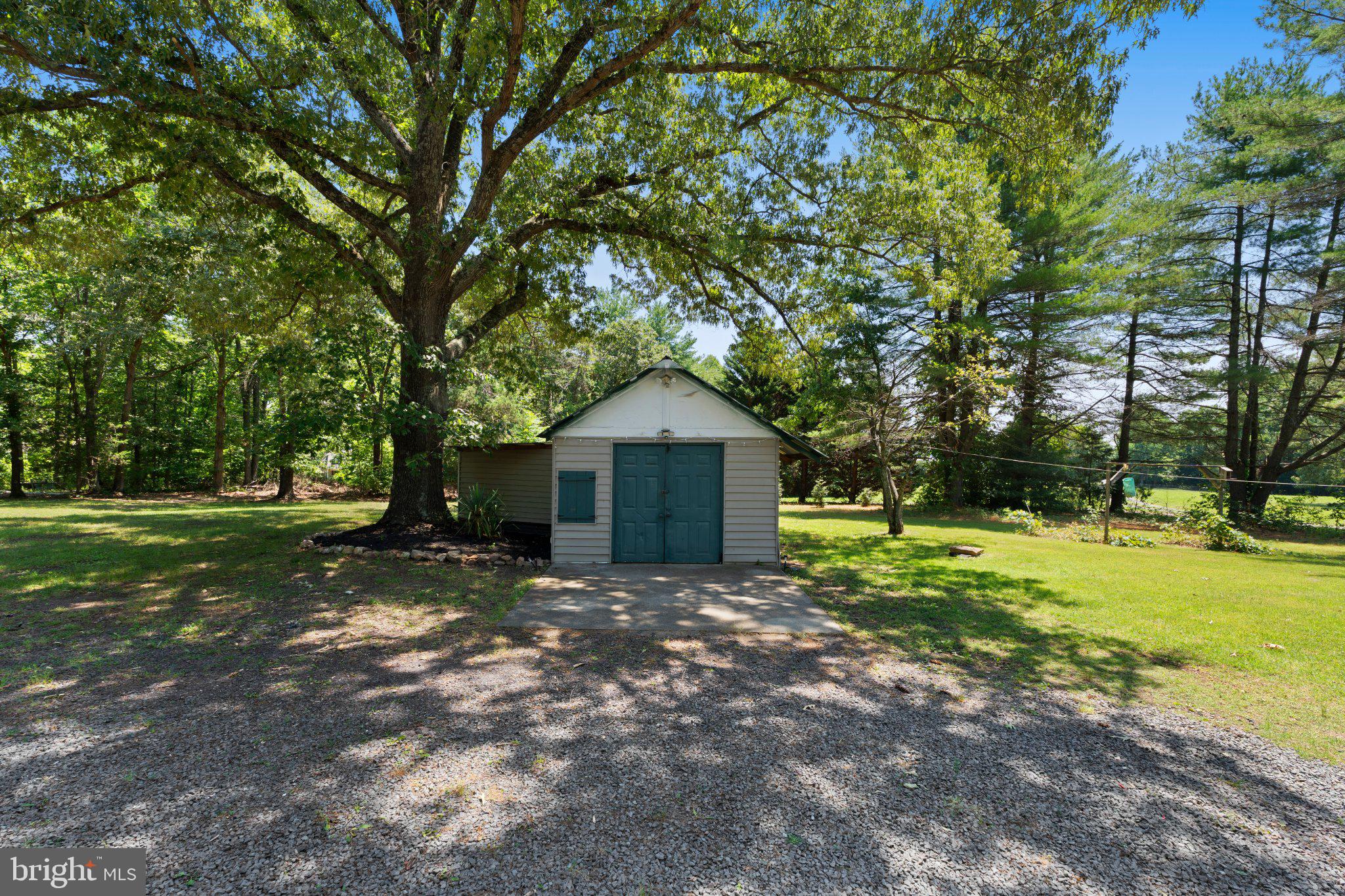 8405 Shirley Road Spotsylvania, VA 22551 - Photo 35 of 42 a backyard of a house with a garden and trees