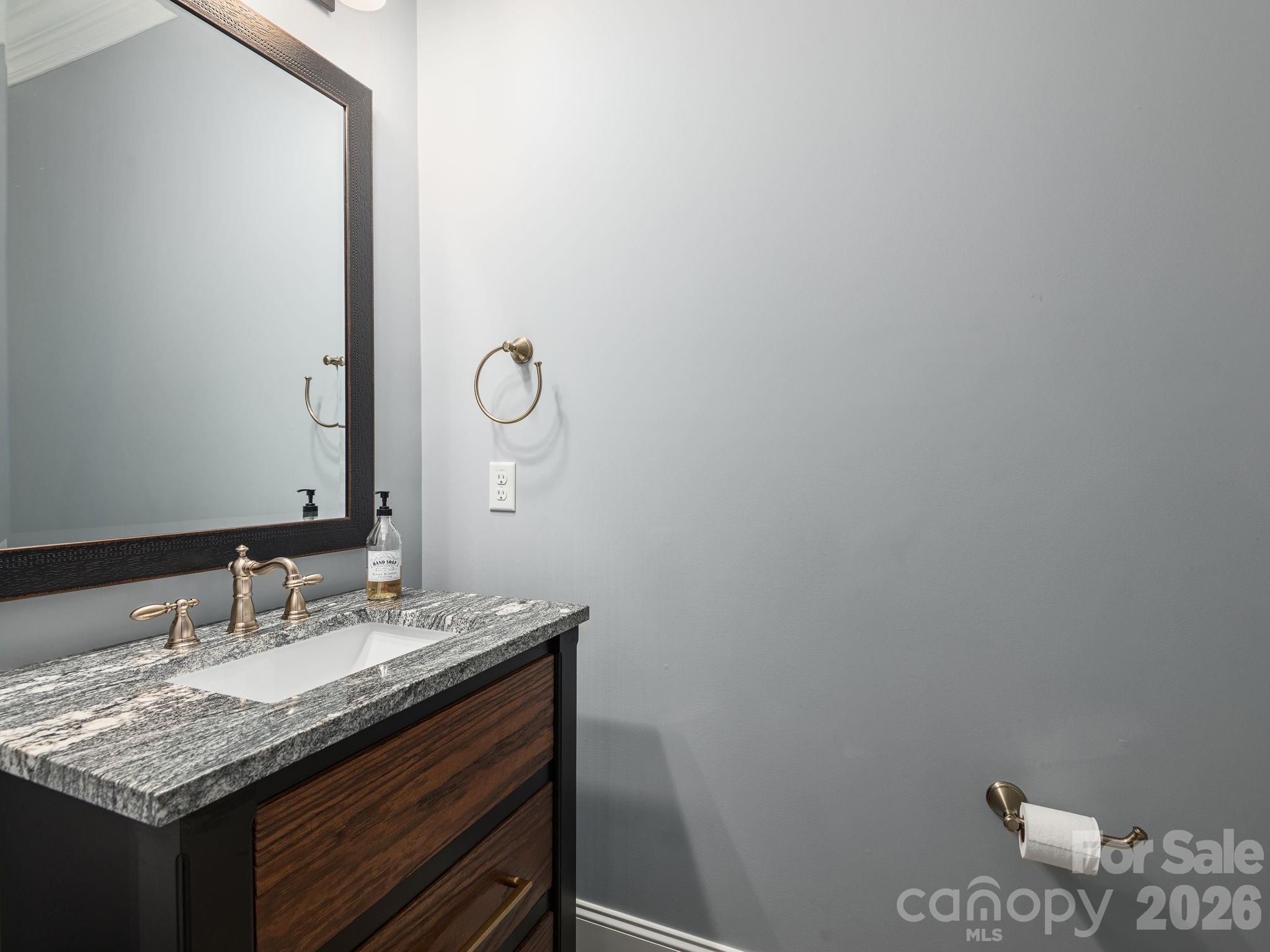 28 Falling Star Court Fletcher, NC 28732 - Photo 14 of 33 a bathroom with a granite countertop sink and a mirror