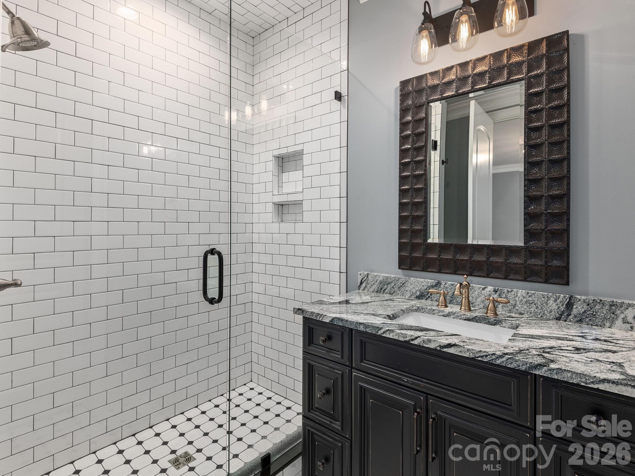 28 Falling Star Court Fletcher, NC 28732 - Photo 19 of 33 a bathroom with a sink a vanity and a shower