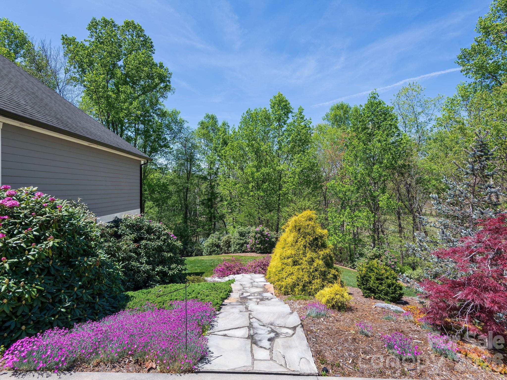 28 Falling Star Court Fletcher, NC 28732 - Photo 25 of 33 a view of a garden with plants and large trees