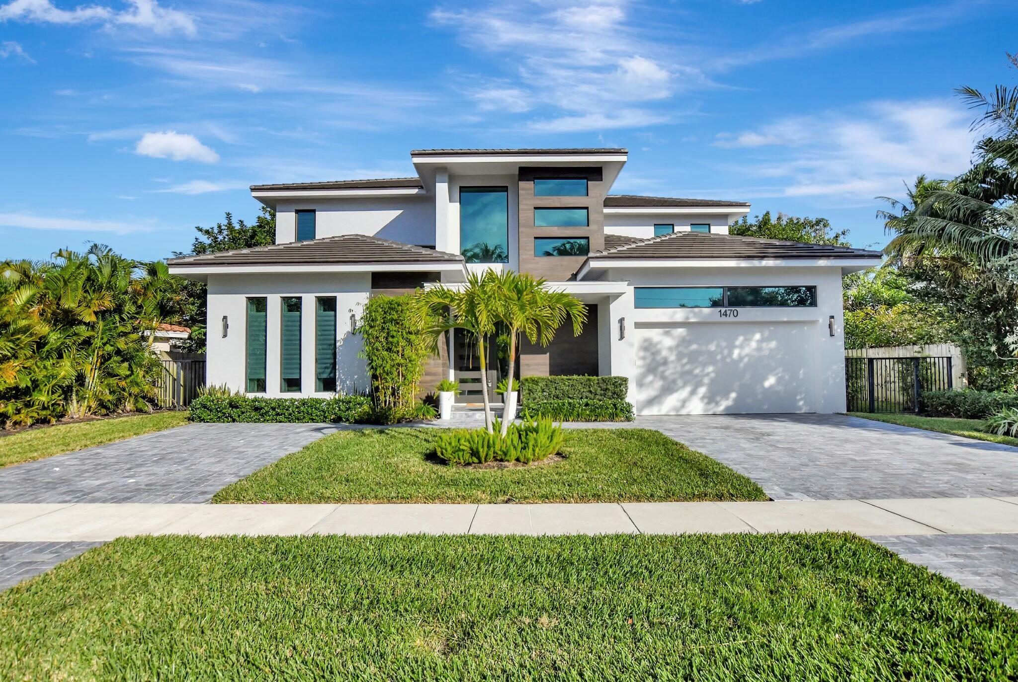 1470 Northeast 4th Avenue Boca Raton, FL 33432 - Photo 2 of 86 a front view of a house with a yard