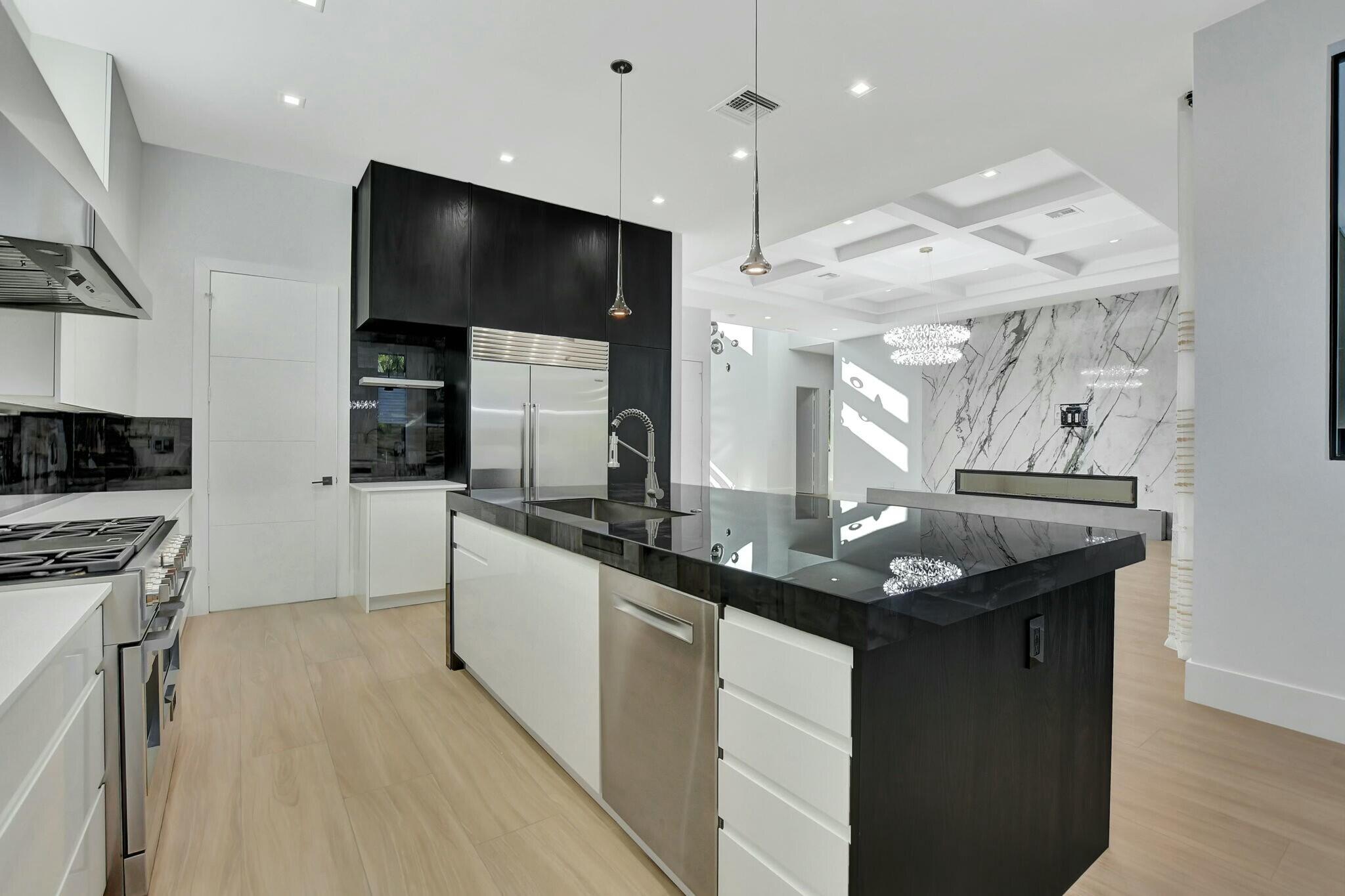 1470 Northeast 4th Avenue Boca Raton, FL 33432 - Photo 28 of 86 a kitchen with granite countertop a sink and a stove