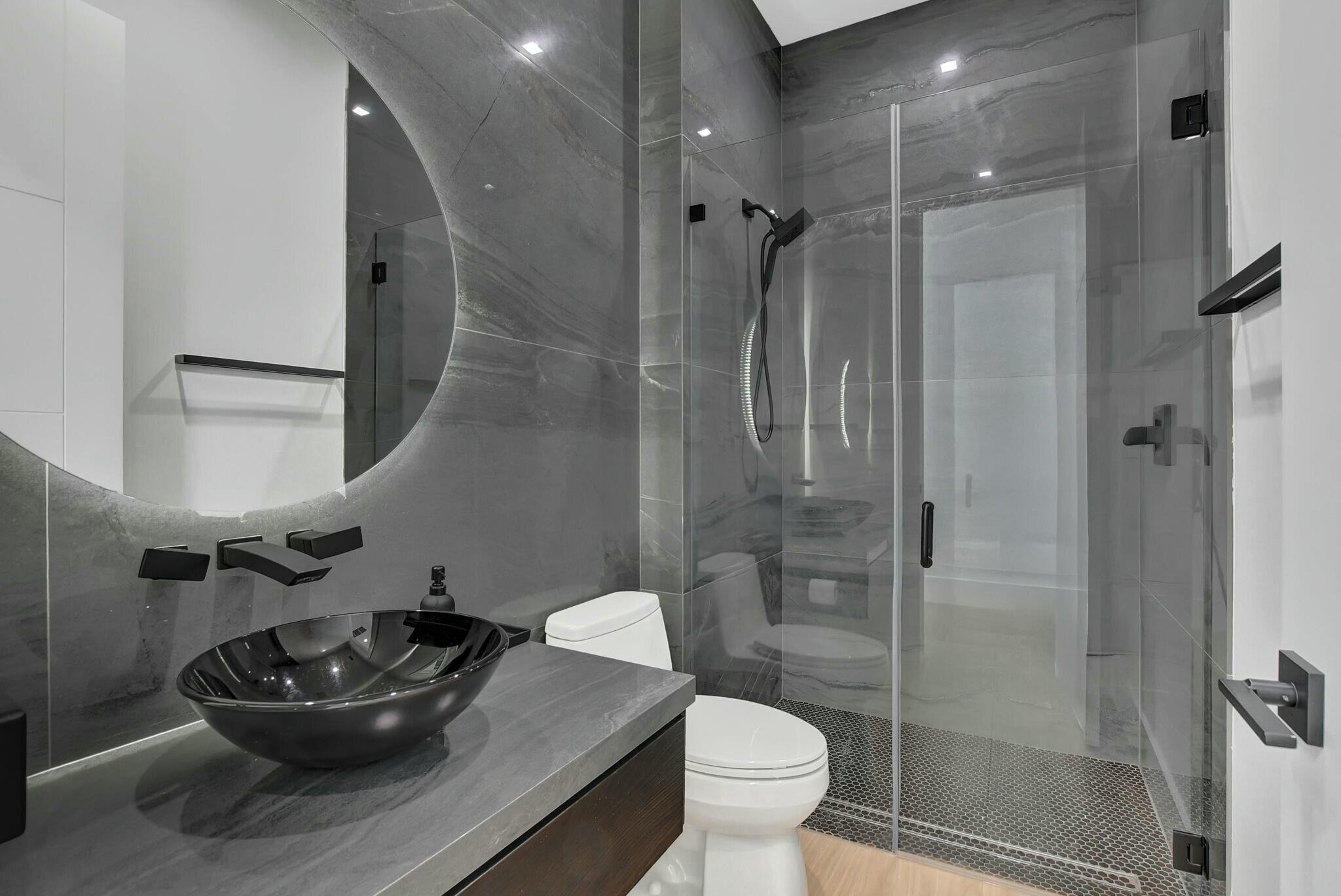 1470 Northeast 4th Avenue Boca Raton, FL 33432 - Photo 44 of 86 a bathroom with a sink a toilet and shower