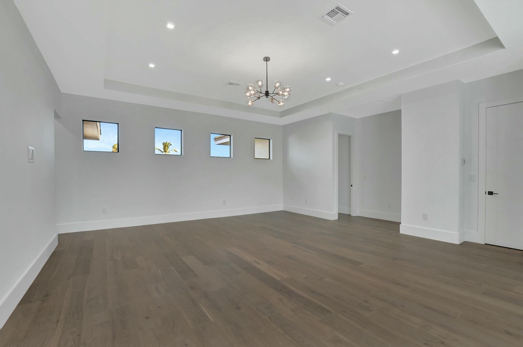 1470 Northeast 4th Avenue Boca Raton, FL 33432 - Photo 47 of 86 an empty room with wooden floor and windows