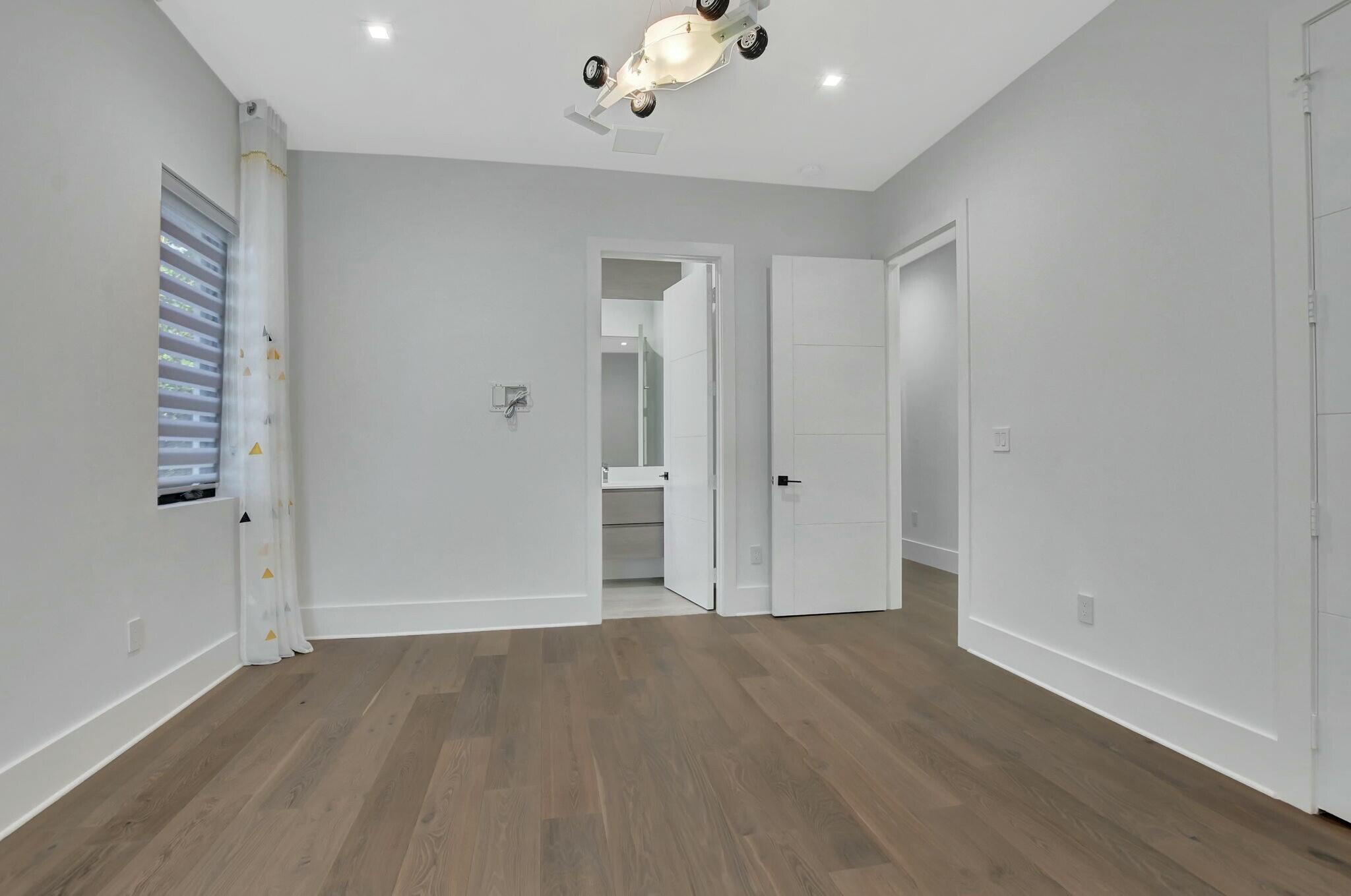 1470 Northeast 4th Avenue Boca Raton, FL 33432 - Photo 61 of 86 wooden floor in an empty room with a window
