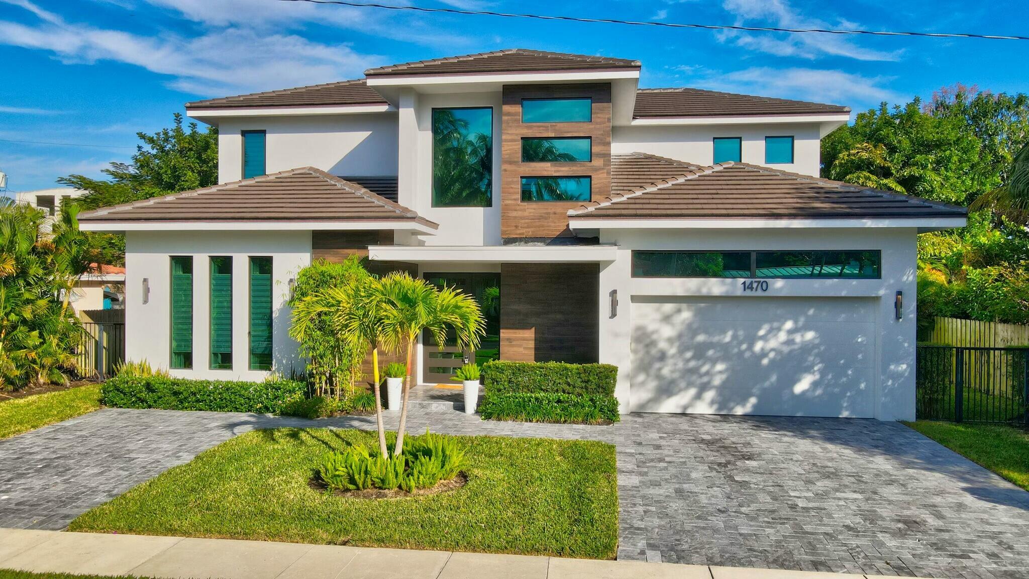 1470 Northeast 4th Avenue Boca Raton, FL 33432 - Photo 74 of 86 a front view of a house with a yard