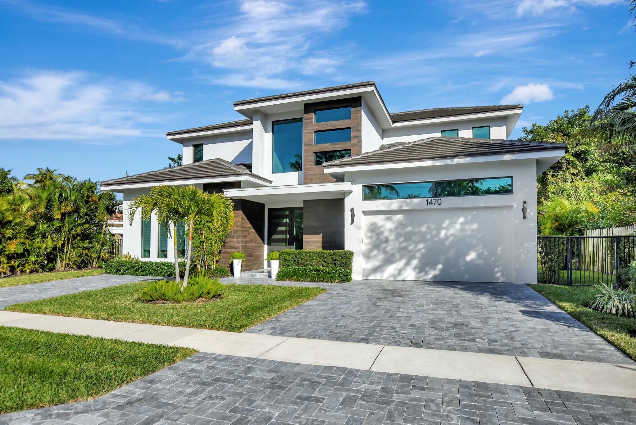 1470 Northeast 4th Avenue Boca Raton, FL 33432 - Photo 86 of 86 a front view of a house with a yard and garage