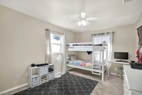 a bed room with a bed and a chair