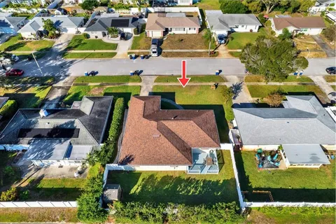 an aerial view of a houses with yard