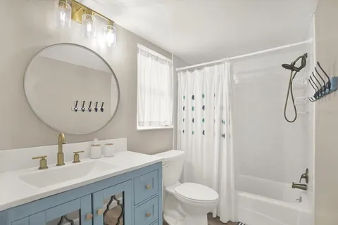 a bathroom with a sink a toilet and a mirror