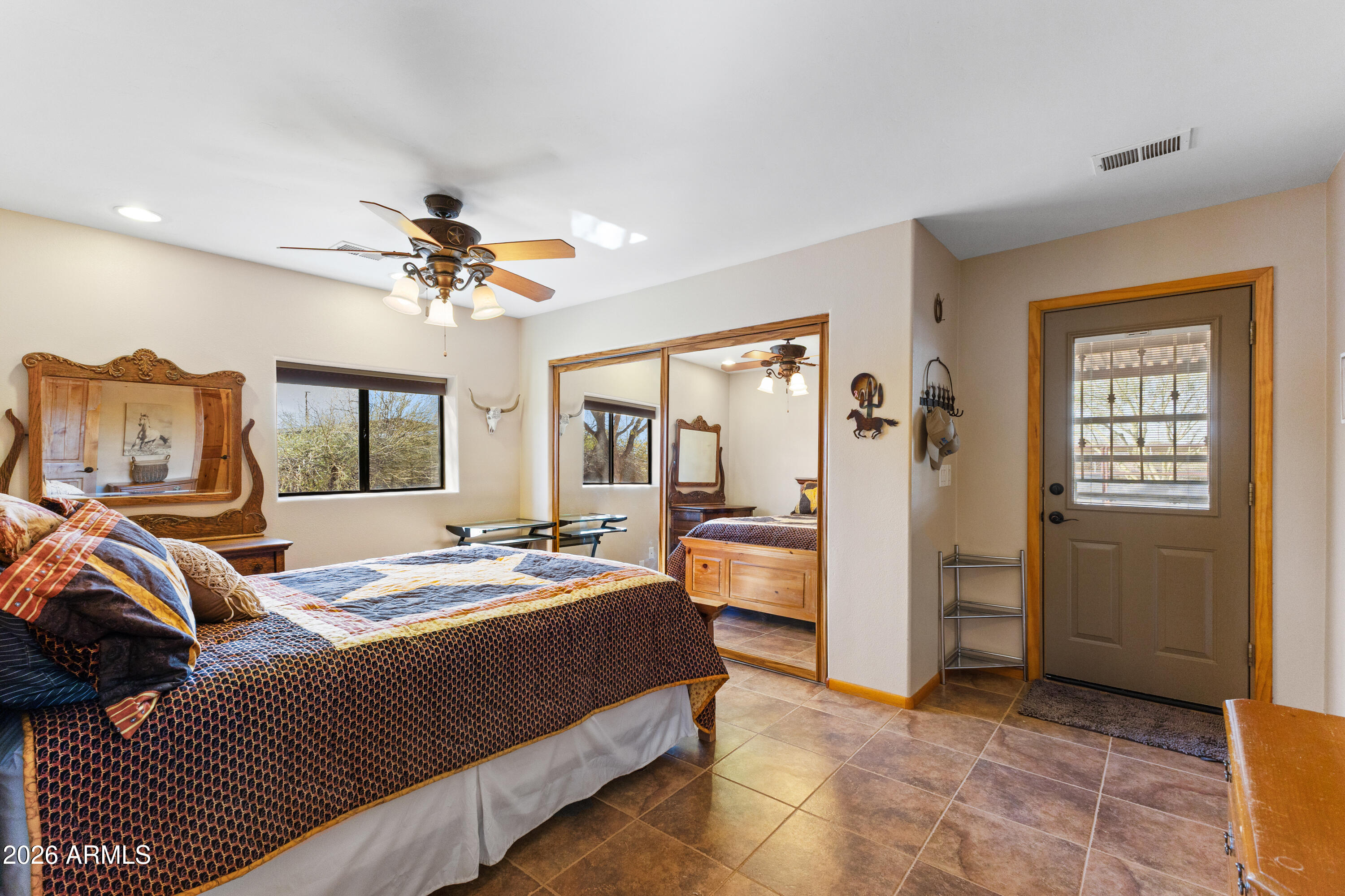 20526 West Carver Road Buckeye, AZ 85326 - Photo 11 of 43 a bedroom with a bed and large windows