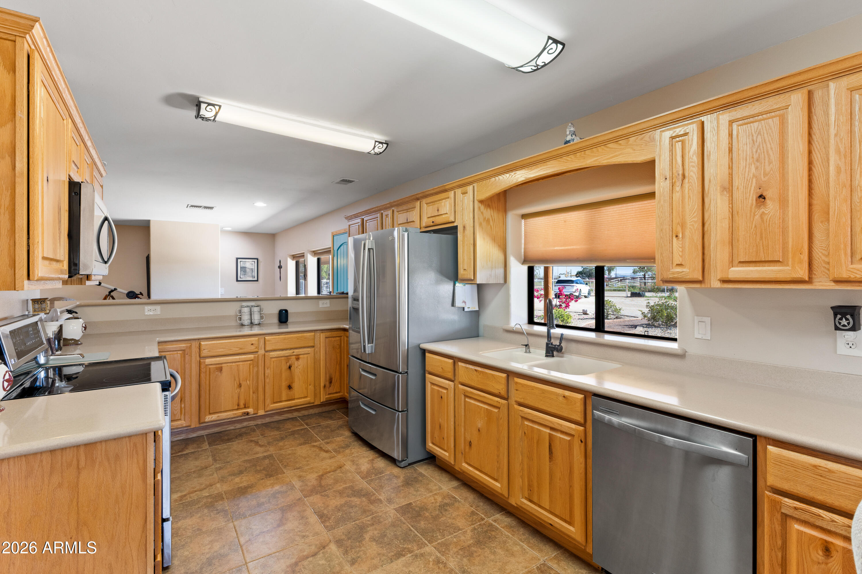 20526 West Carver Road Buckeye, AZ 85326 - Photo 18 of 43 a kitchen with kitchen island granite countertop a sink appliances cabinets and furniture