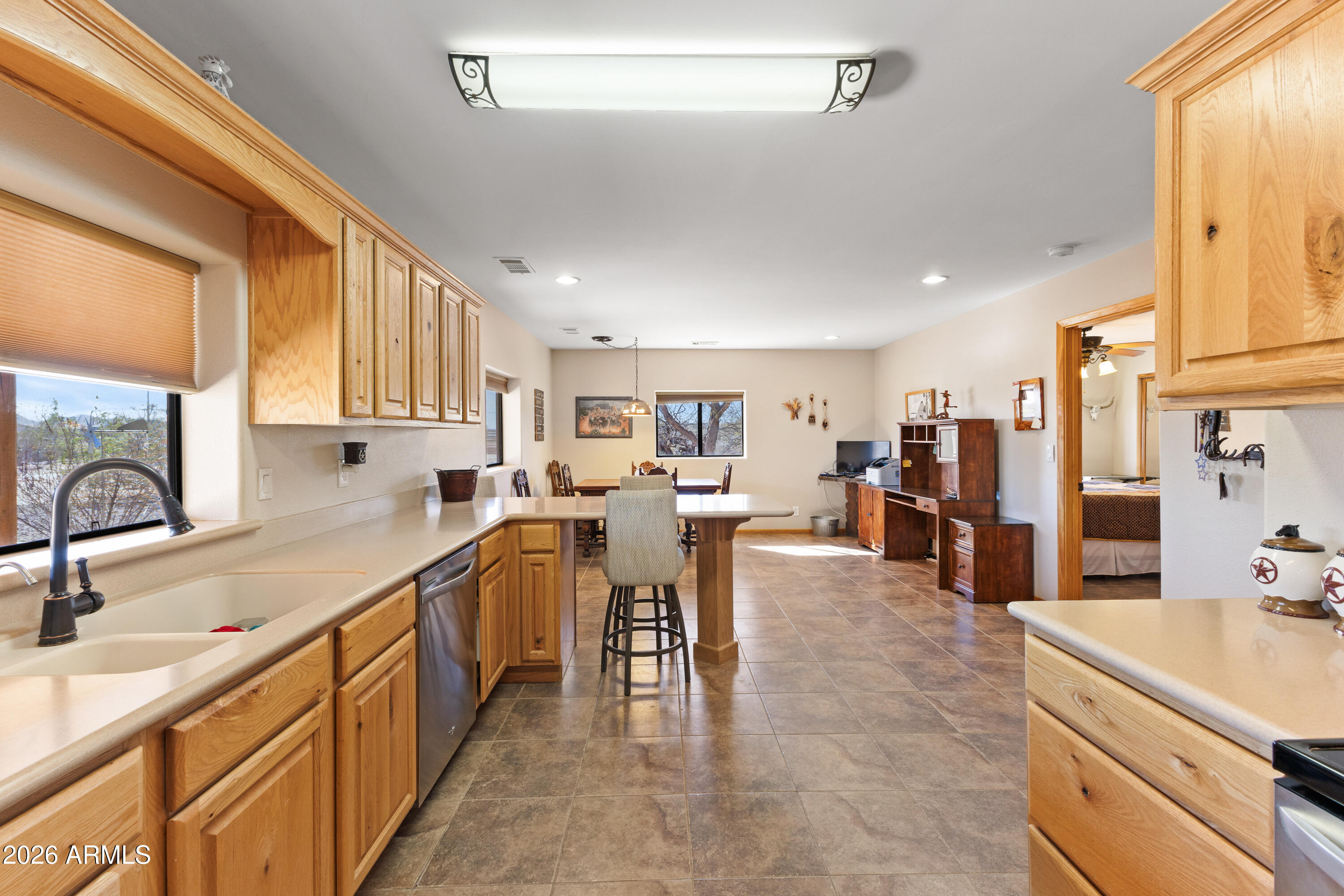 20526 West Carver Road Buckeye, AZ 85326 - Photo 19 of 43 a large white kitchen with lots of counter top space and a sink