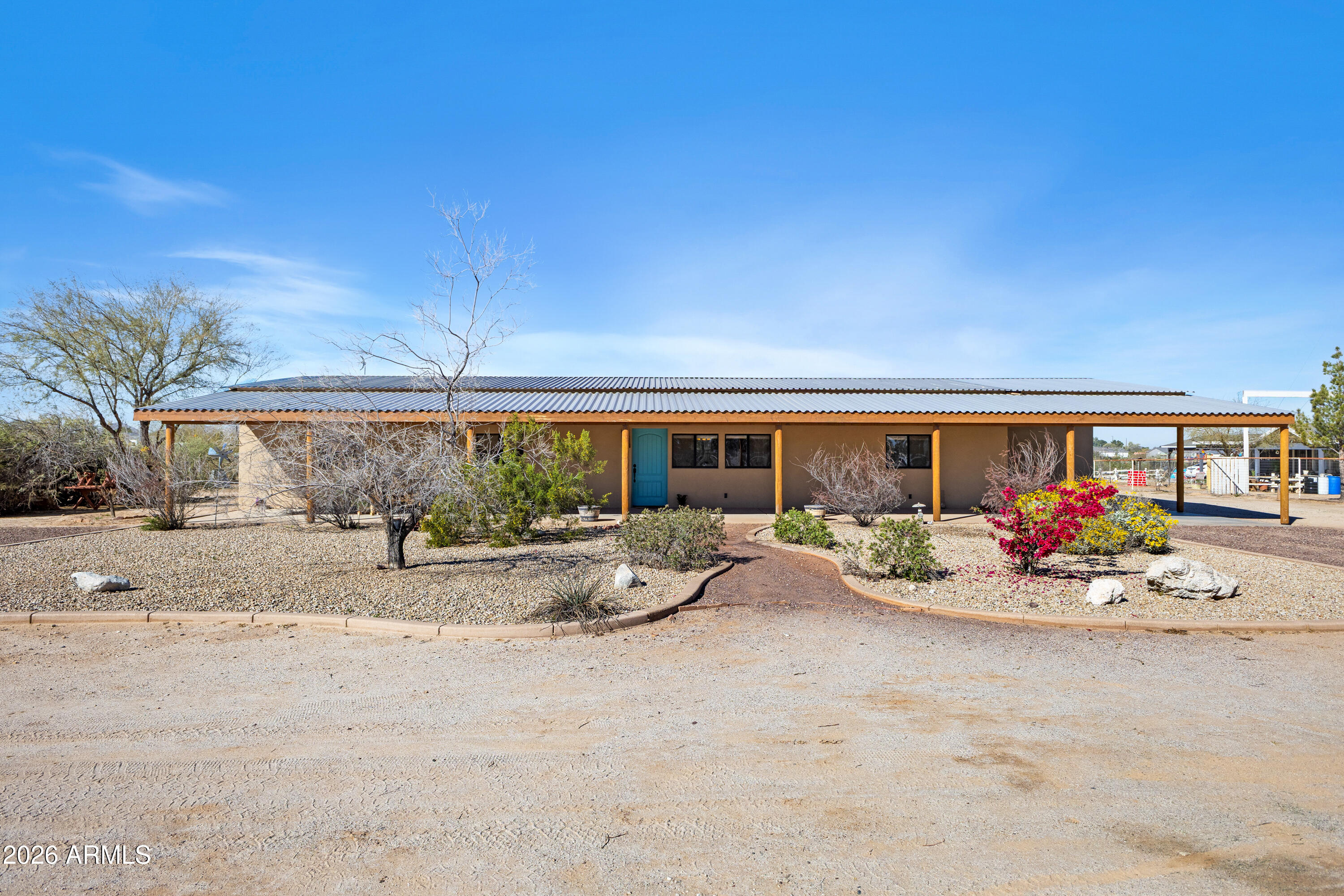 20526 West Carver Road Buckeye, AZ 85326 - Photo 2 of 43 a view of a patio with dining table and chairs under an umbrella