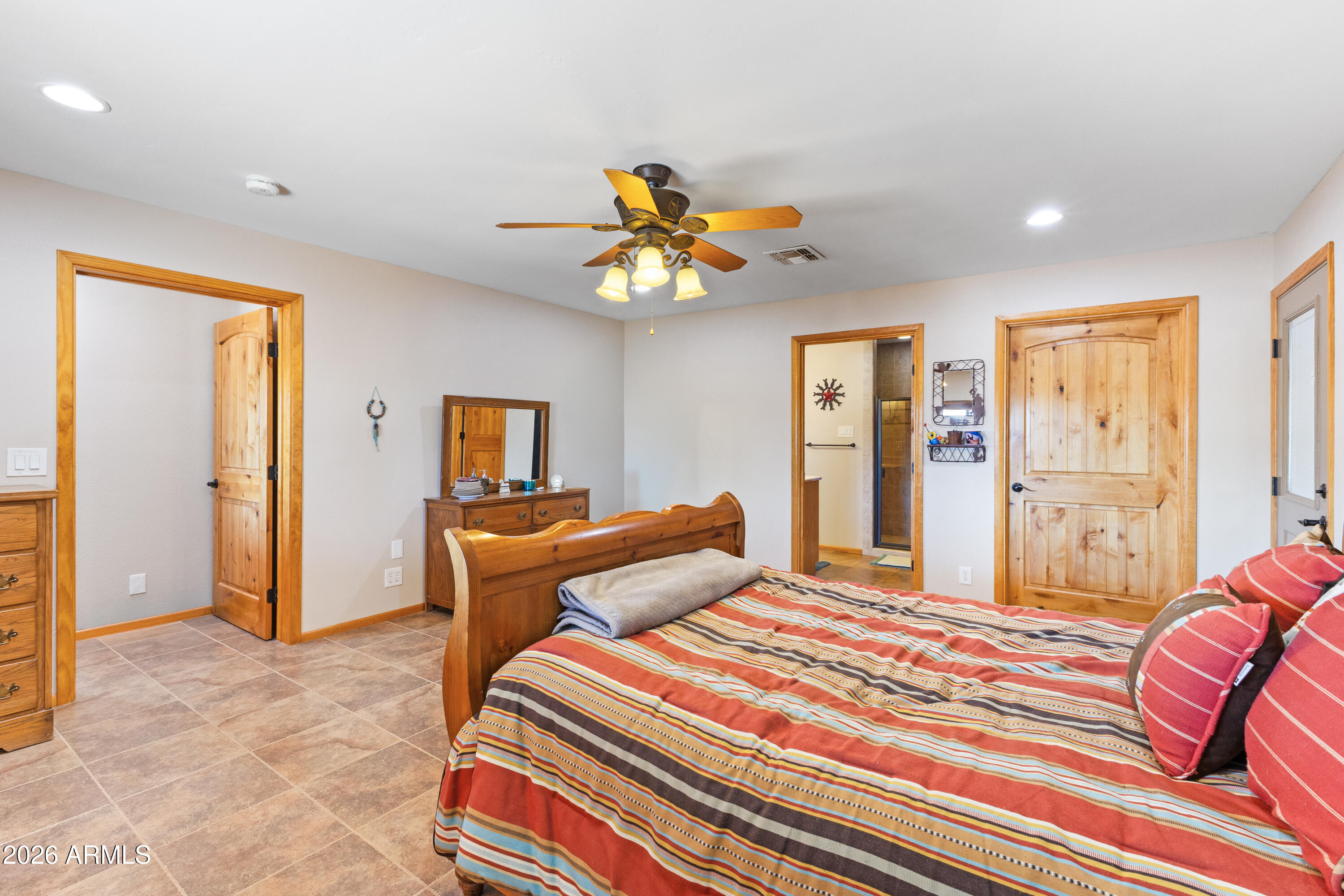 20526 West Carver Road Buckeye, AZ 85326 - Photo 21 of 43 a bedroom with a bed and a chandelier