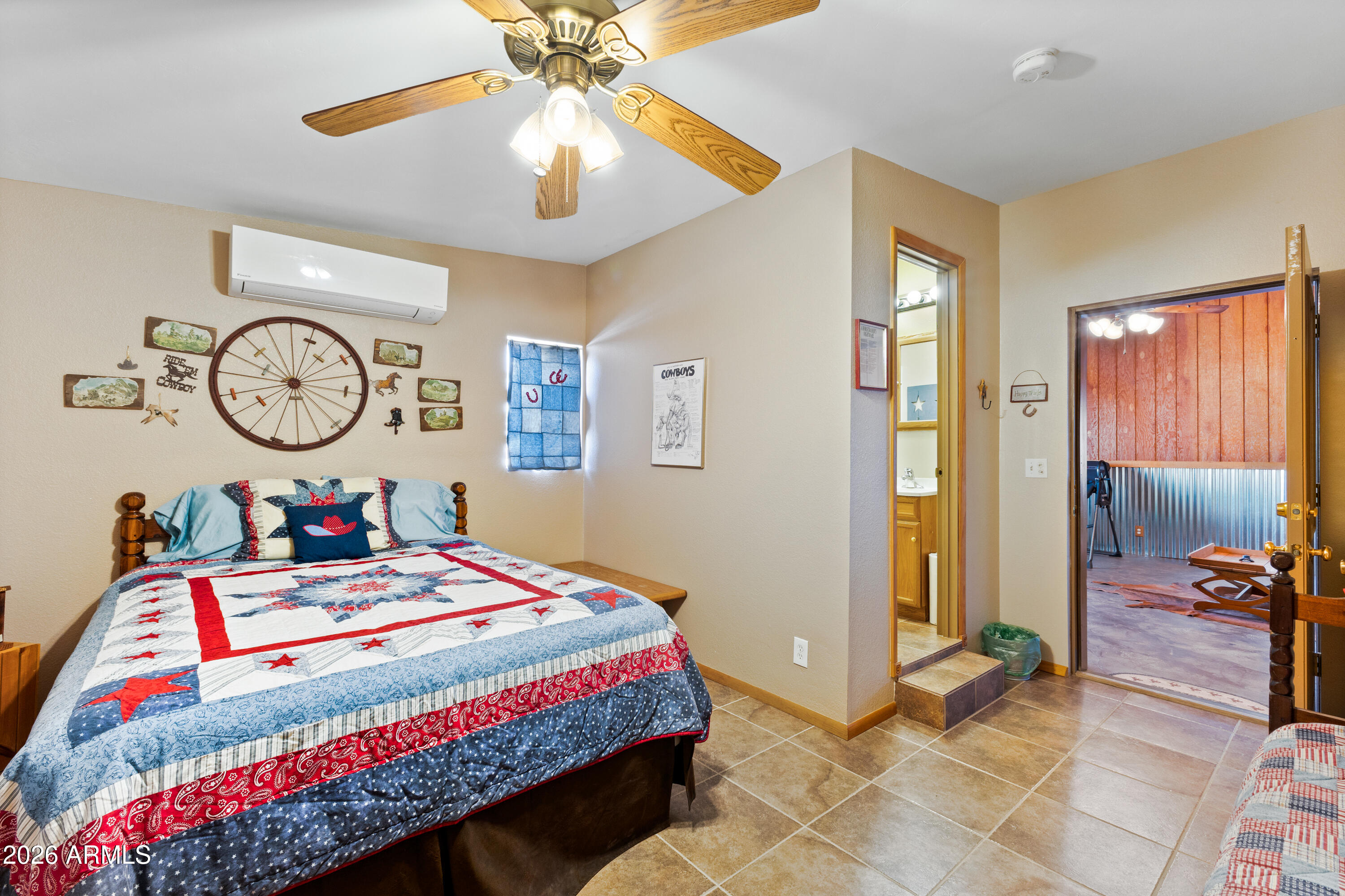 20526 West Carver Road Buckeye, AZ 85326 - Photo 28 of 43 a bedroom with a bed and a chandelier