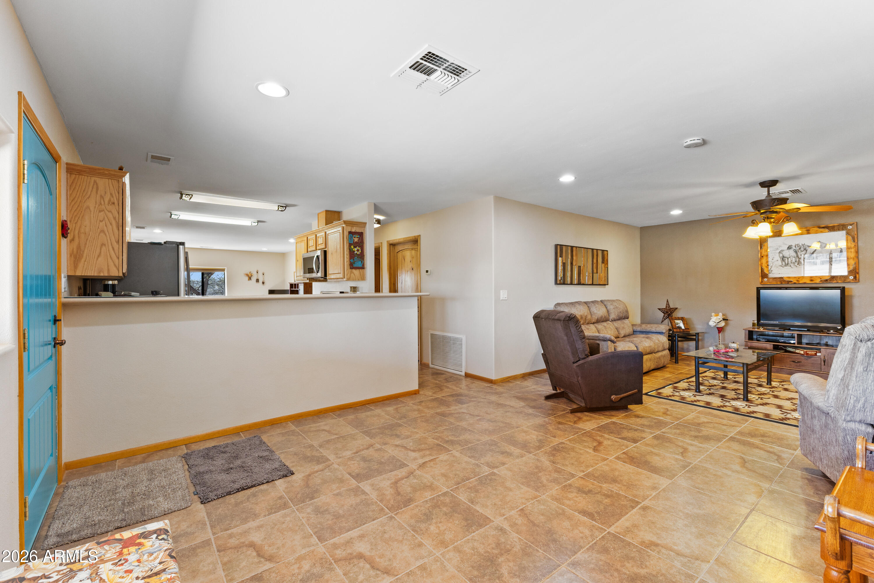 20526 West Carver Road Buckeye, AZ 85326 - Photo 4 of 43 a living room with furniture and a flat screen tv