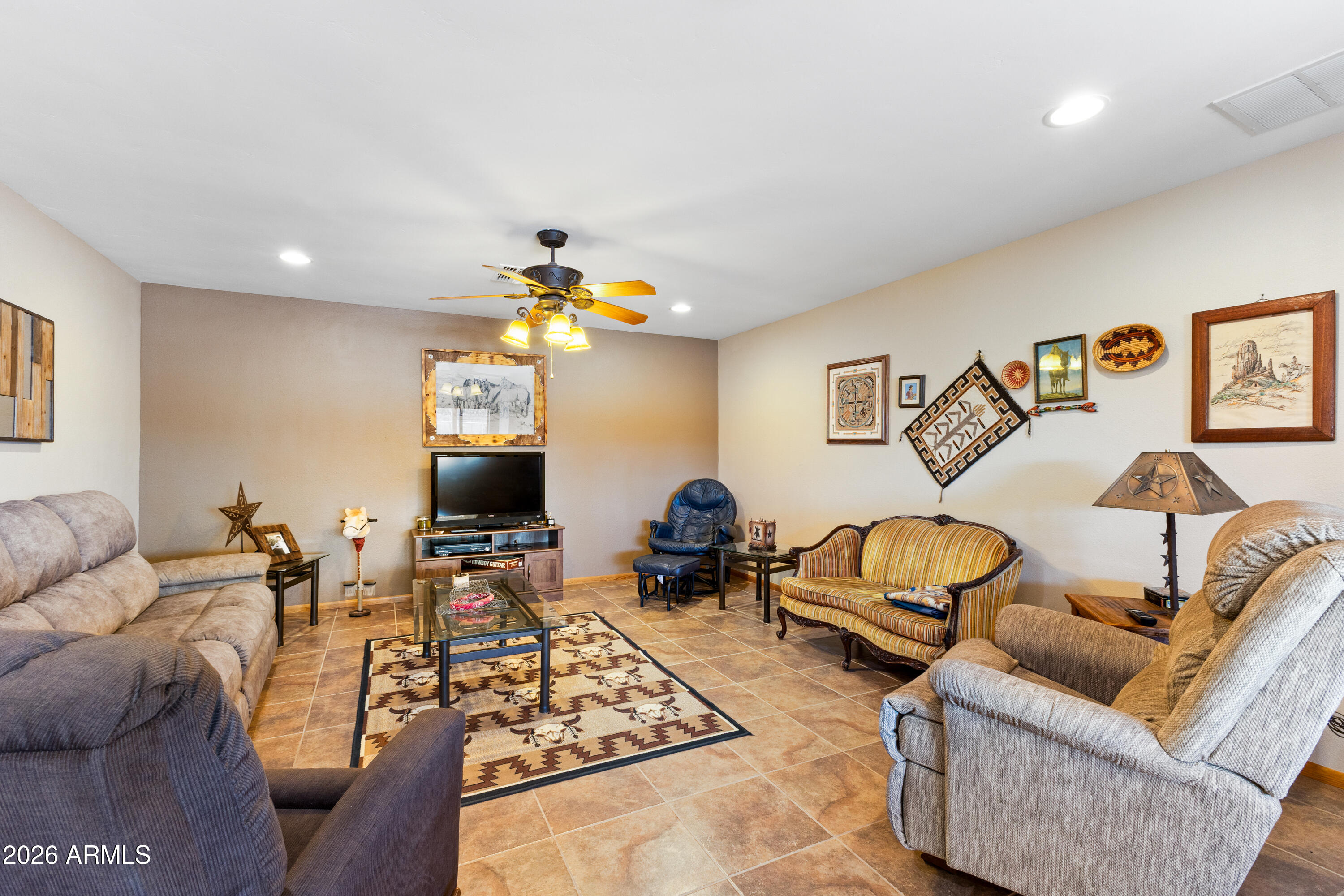 20526 West Carver Road Buckeye, AZ 85326 - Photo 5 of 43 a living room with furniture and a flat screen tv