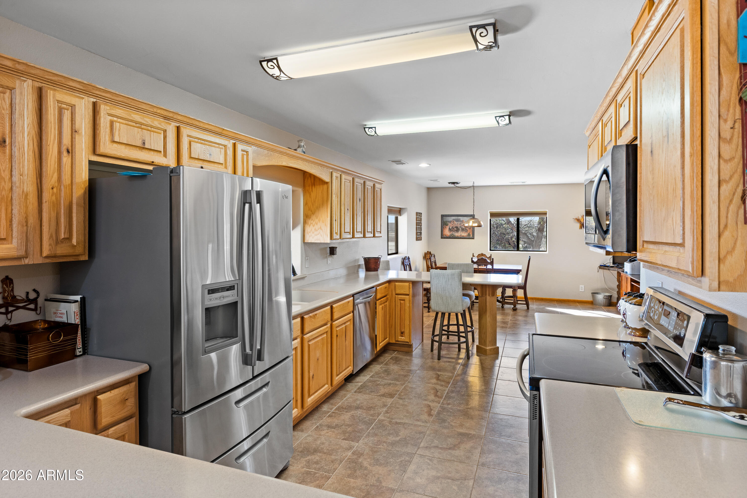 20526 West Carver Road Buckeye, AZ 85326 - Photo 8 of 43 a kitchen with counter top space and refrigerator