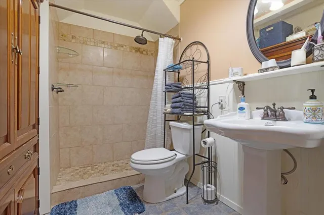 a bathroom with a sink toilet and shower