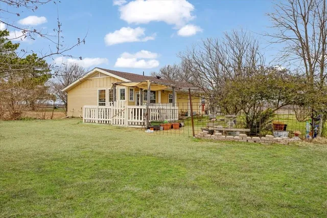 an aerial view of a house with a yard basket ball court