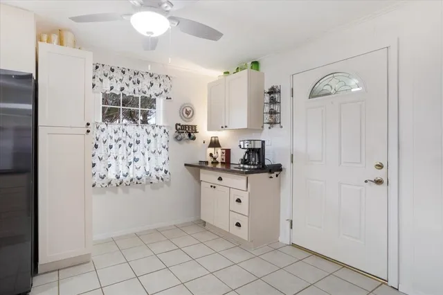a kitchen with granite countertop white cabinets and stainless steel appliances