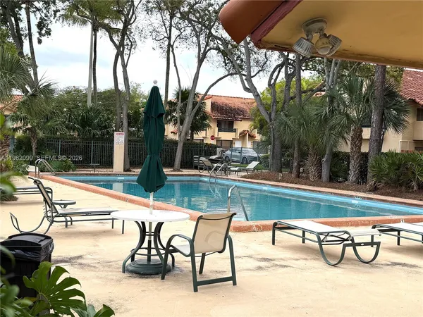 a view of a patio with a table and chairs