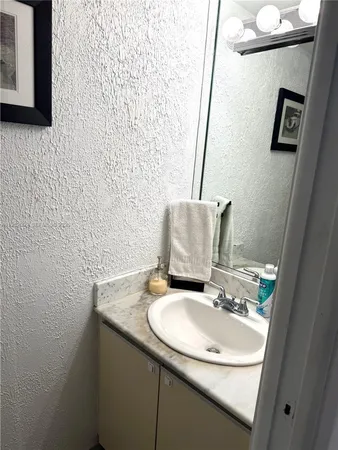 a bedroom with a bed and large windows