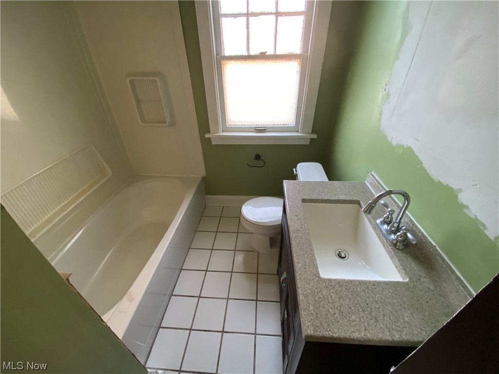3630 Bainbridge Road Cleveland Heights, OH 44118 - Photo 15 of 21 Full bathroom featuring tile floors, toilet, vanity, and shower / washtub combination