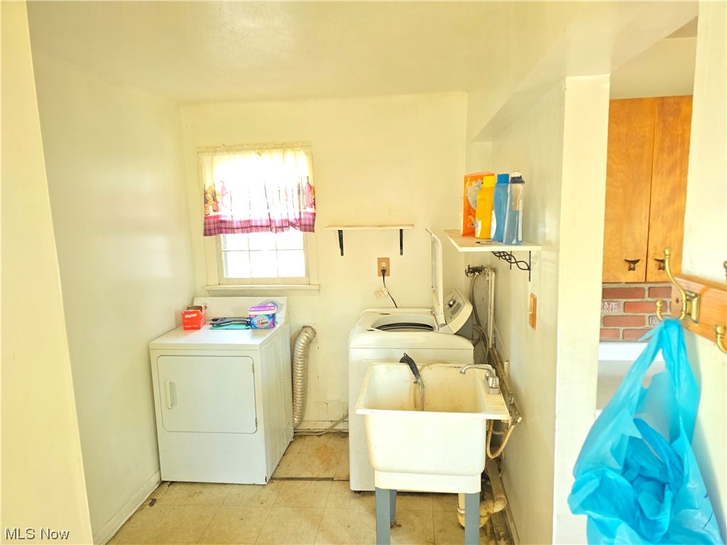 1450 Bonnie Road Macedonia, OH 44056 - Photo 20 of 21 Laundry room featuring independent washer and dryer, light tile flooring, and sink