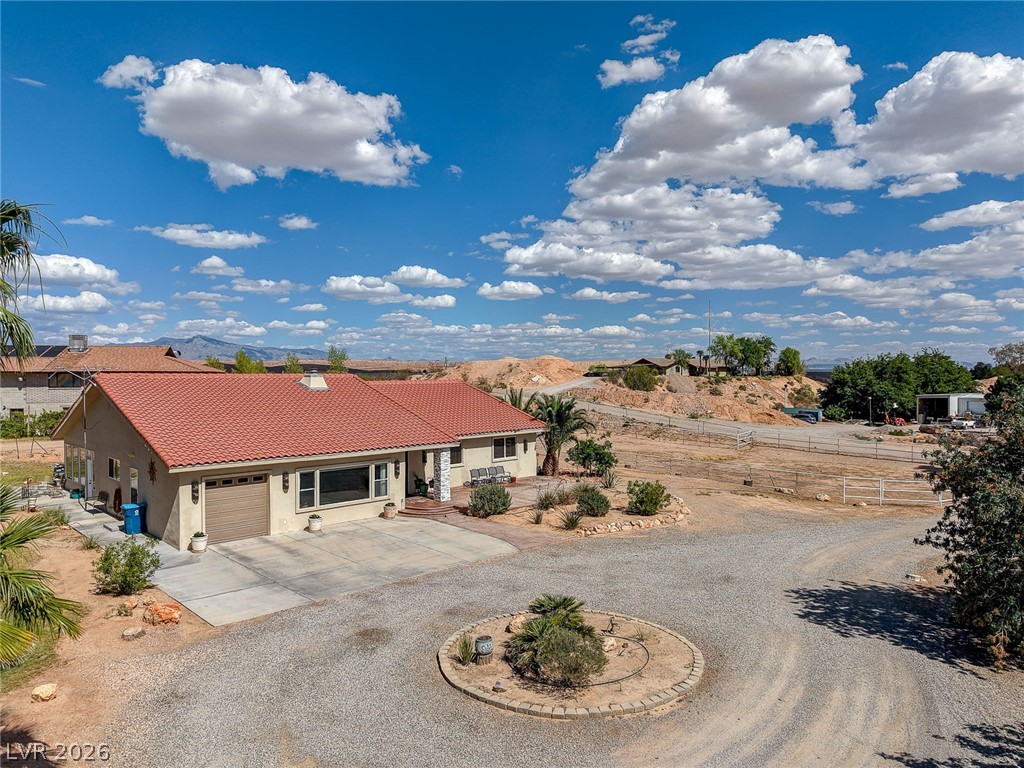 1950 Bowman Road Logandale, NV 89021 - Photo 72 of 81 A well-maintained desert oasis features a red tile roof and expansive gravel driveway.