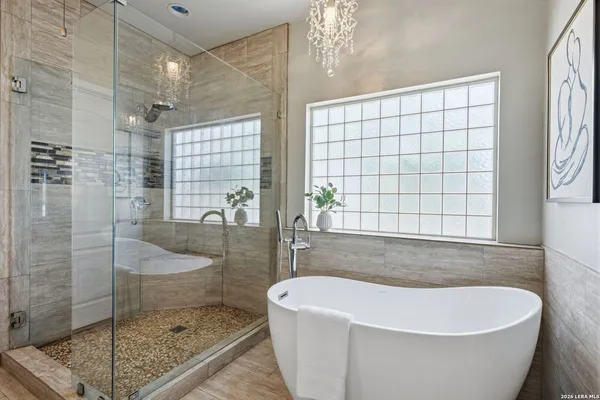 a white bath tub sitting next to a shower