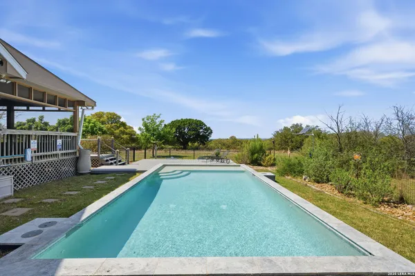 a view of a swimming pool with a yard