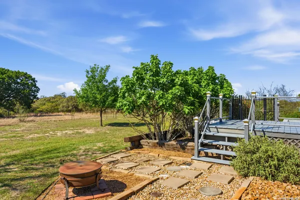 a backyard of a house with table and chairs