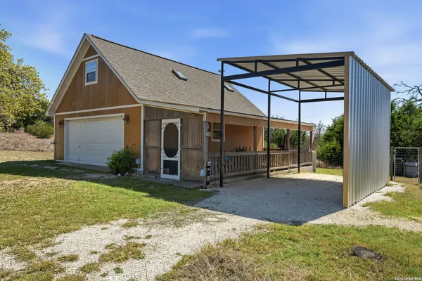 a view of a house with backyard and porch