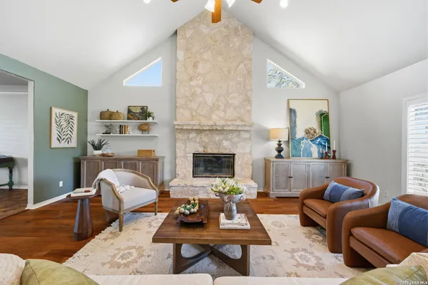 a living room with furniture a rug and a fireplace