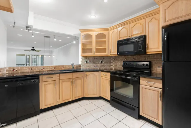 a kitchen with stainless steel appliances granite countertop a stove microwave and sink