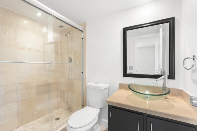 a bathroom with a sink toilet and shower