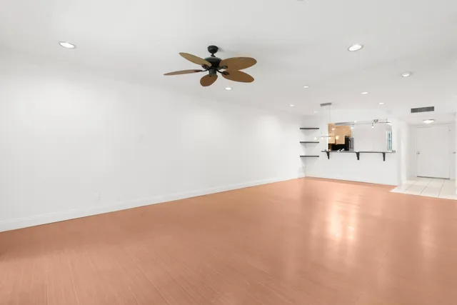 an empty room with a empty space and a ceiling fan