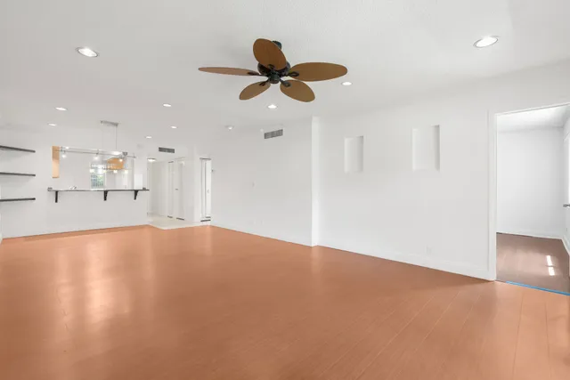 a view of an empty room with a kitchen